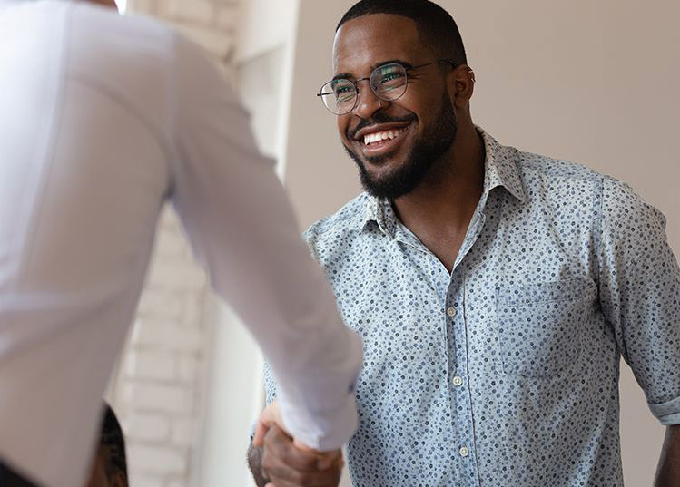 Two Smiling Businessmen Shaking Hands